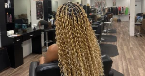 Bohemian knotless braids with curly pieces left out along the length